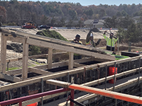 View of crossed metal beam construction overseeing worksite.